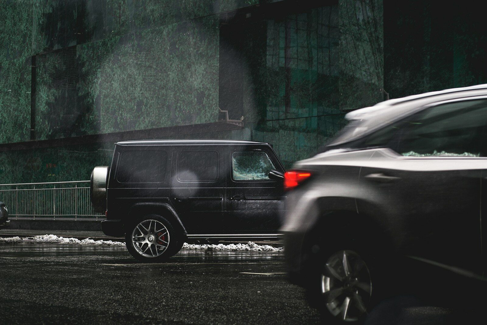 a black suv is parked on the side of the road