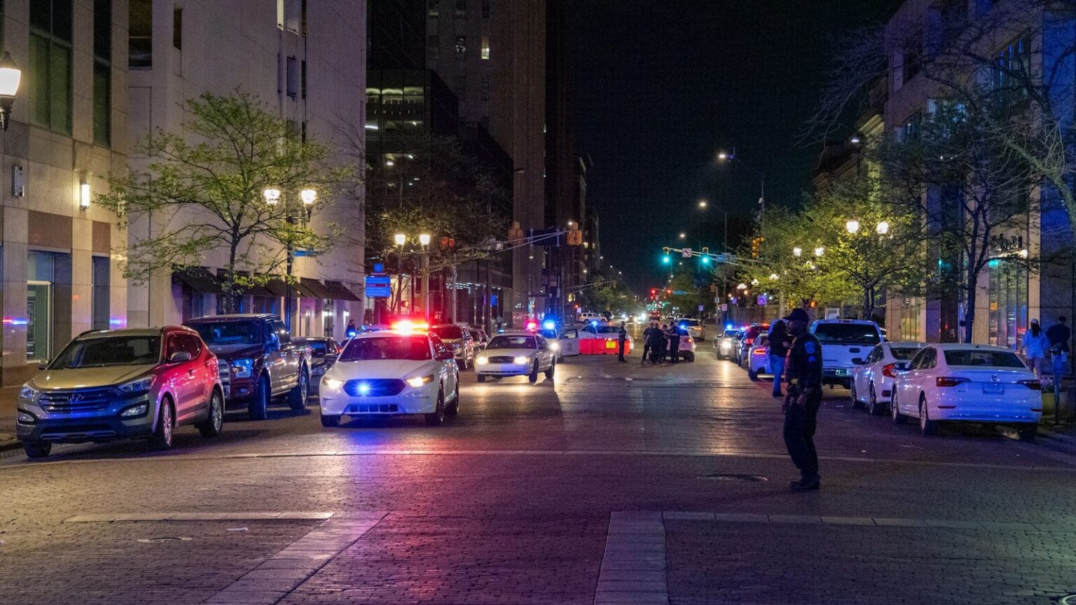 A police officer standing on the side of a street