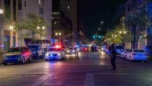 A police officer standing on the side of a street