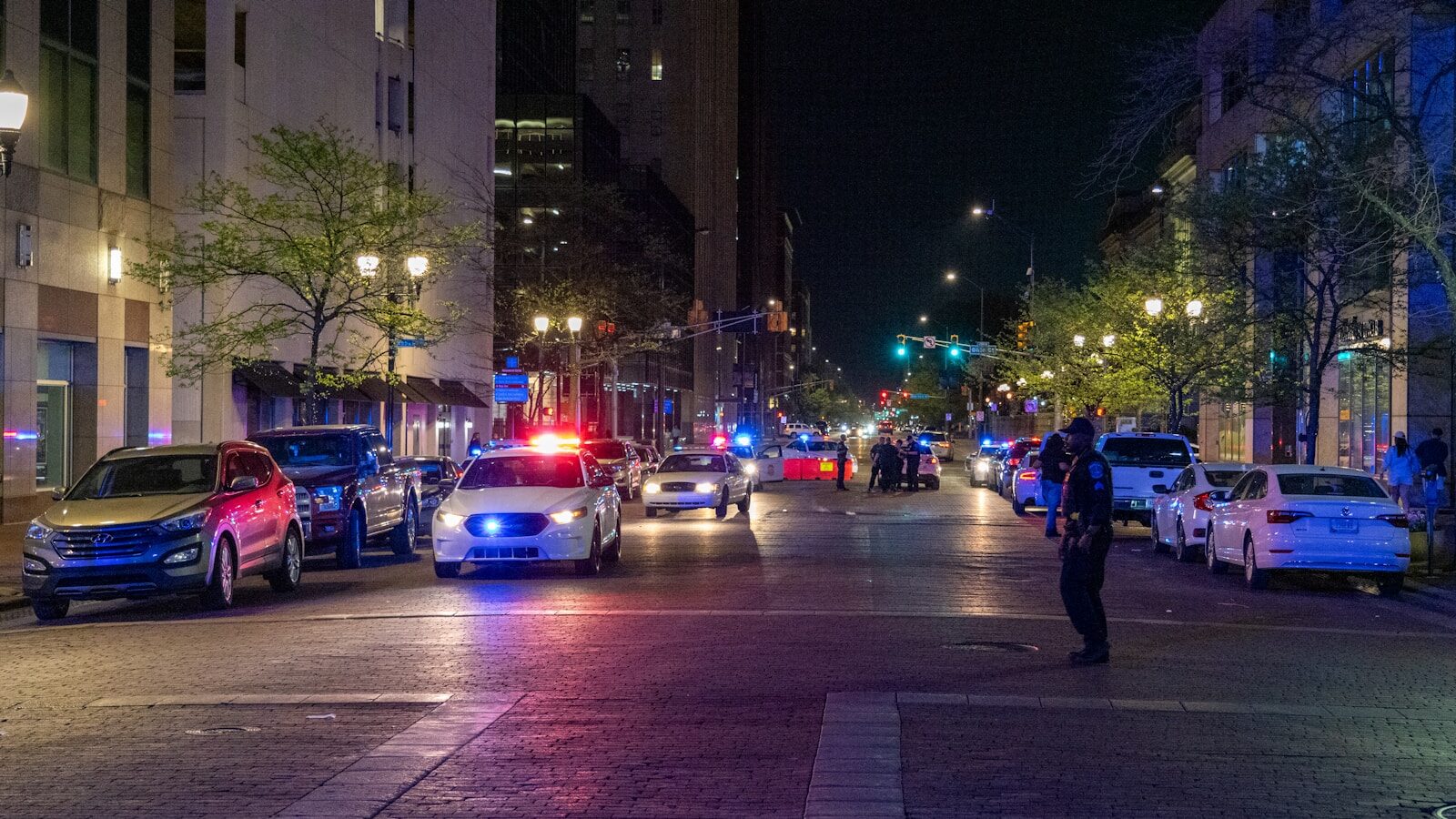 A police officer standing on the side of a street
