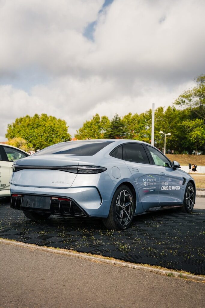 Two cars parked in a parking lot next to each other