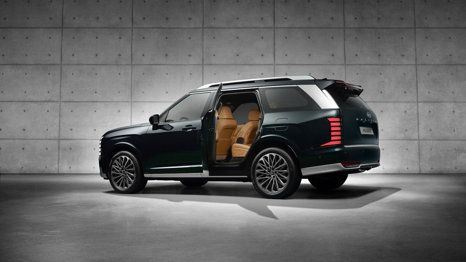A luxury suv with open doors in a garage.