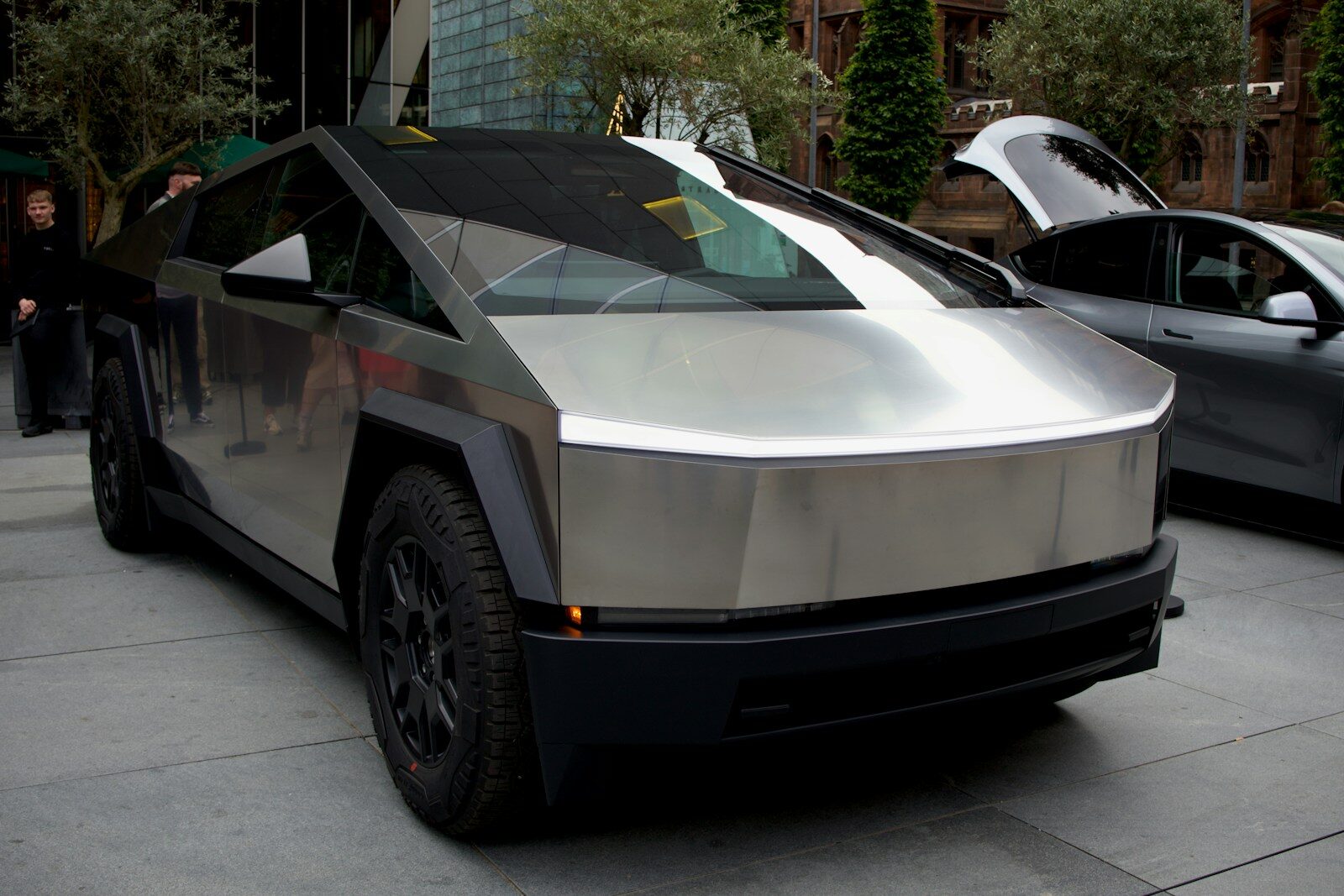 a silver car parked on the side of a street