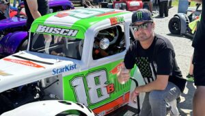 Kurt Busch poses beside Brexton Busch's race car before a grassroots racing event.