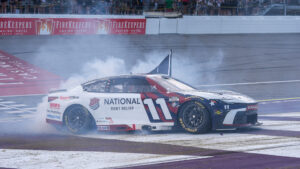 Denny Hamlin celebrates his victory at Michigan International Speedway after earning the 63rd NASCAR Cup Series win of his career.