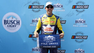 Denny Hamlin poses with the Busch Light Pole Award after qualifying on pole at Pocono Raceway.