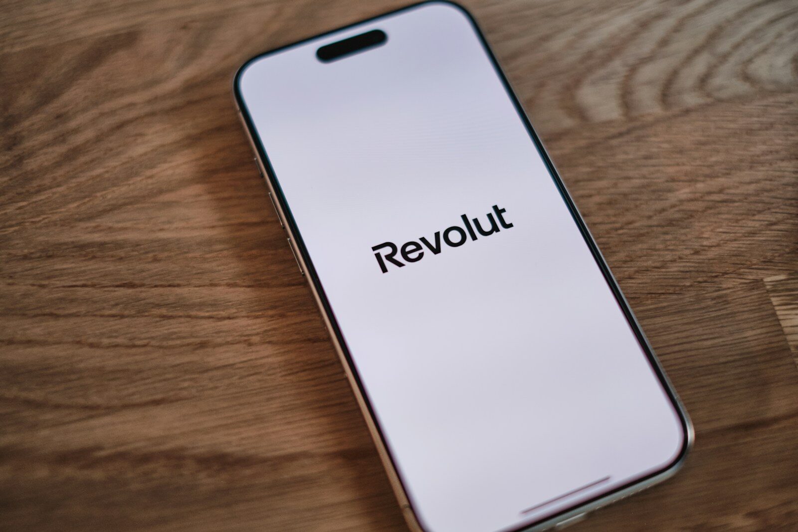 A cell phone sitting on top of a wooden table