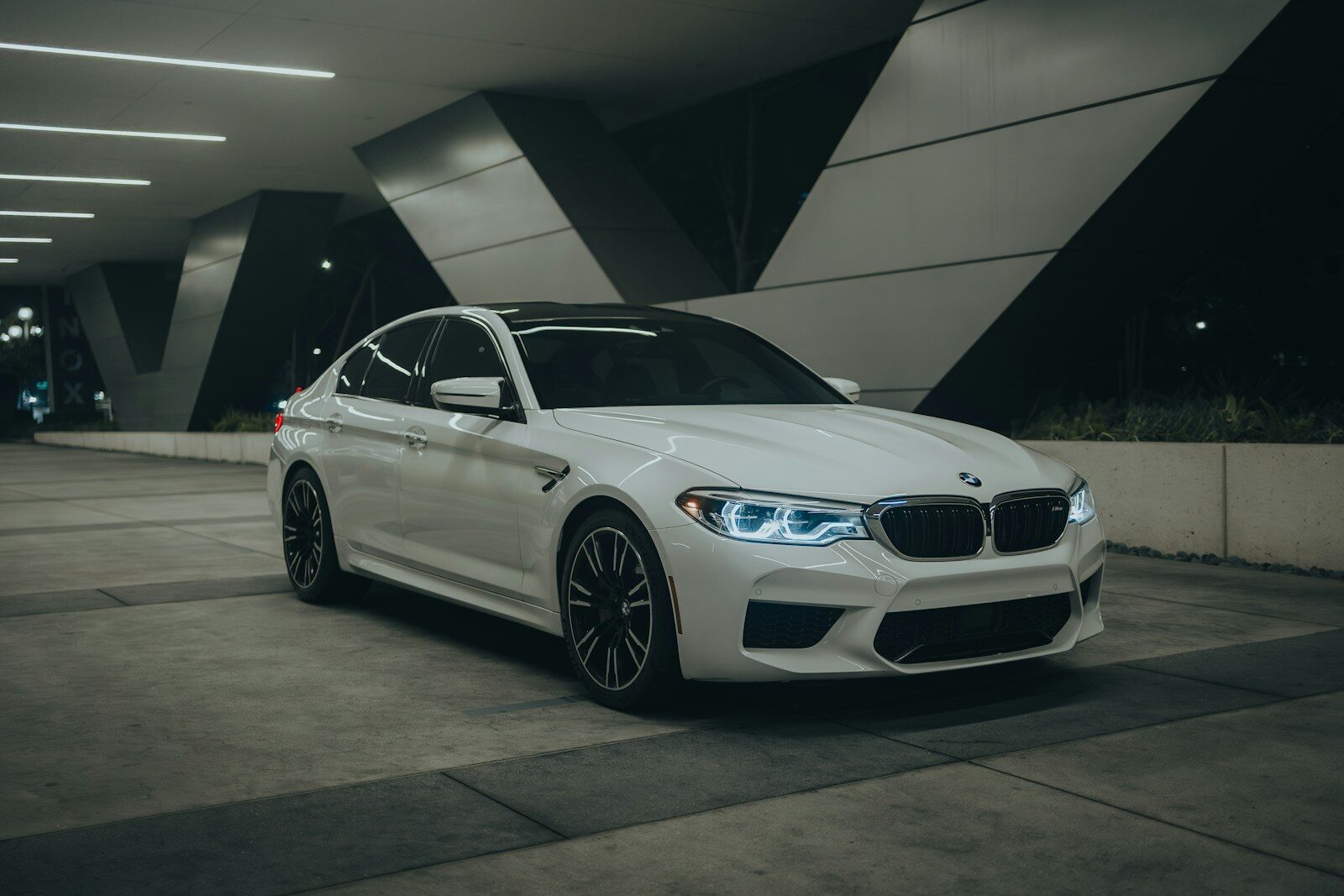 A white car parked in a parking garage