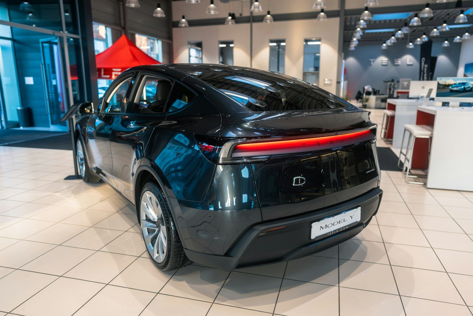 A car is parked inside of a showroom
