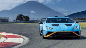 a blue sports car driving on a race track