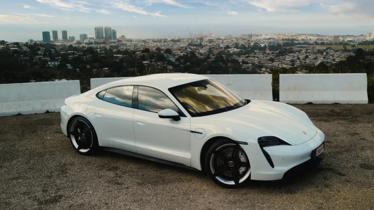 a white sports car parked in a parking lot