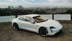 a white sports car parked in a parking lot