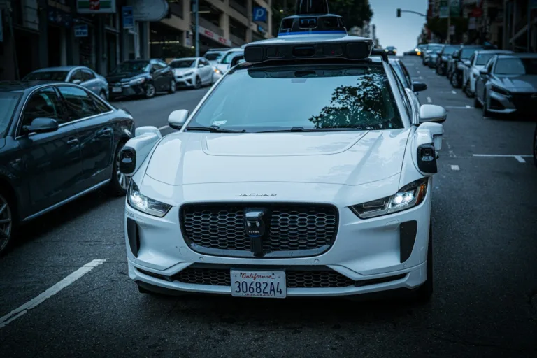 White self-driving car on a city street