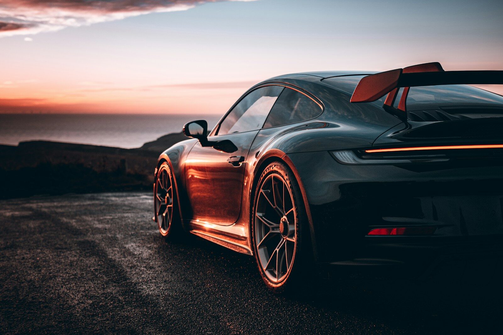 A black sports car parked on the side of a road